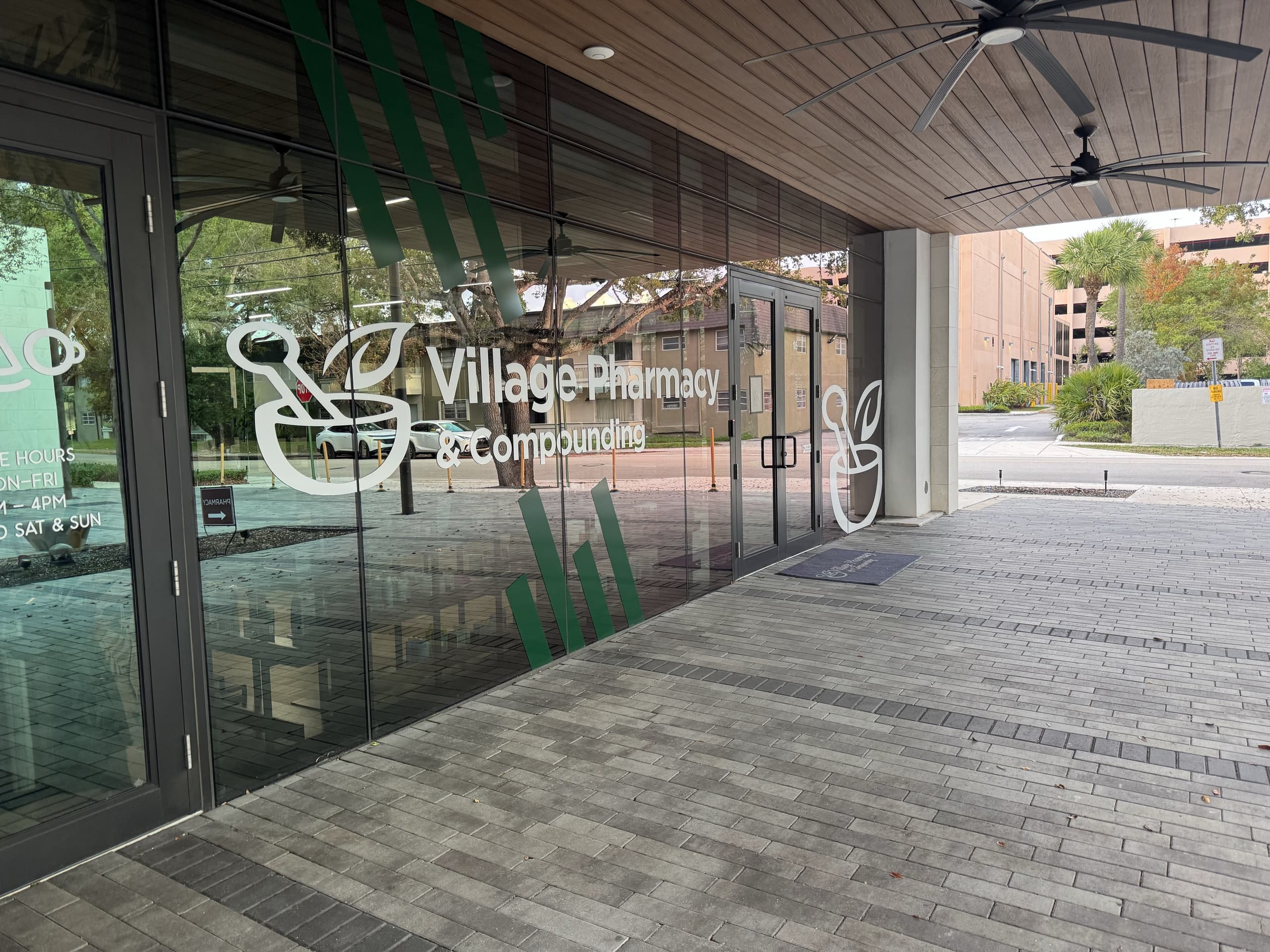 The storefront entrance of Village Pharmacy & Compounding in Miami